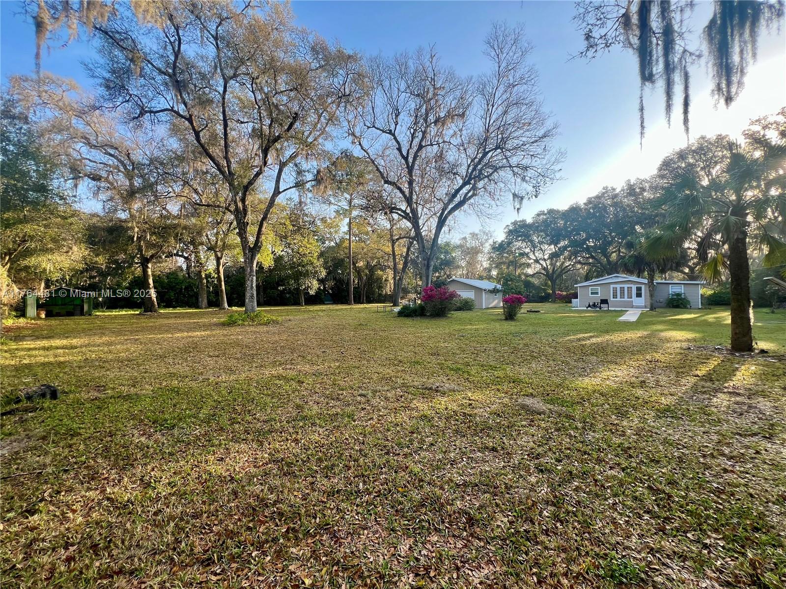 2985 Hilltop Road St. Augustine, FL 32086 - Photo 1 of 26 a view of a tree in front of a house