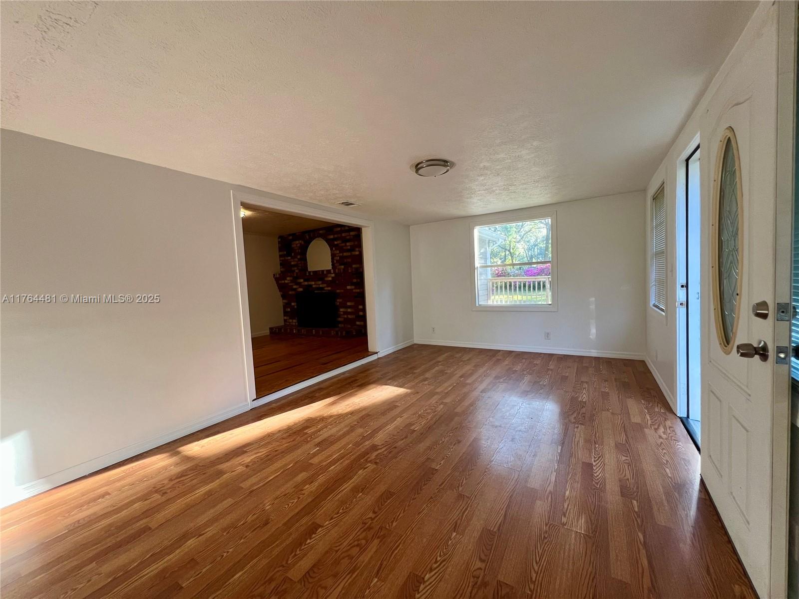 2985 Hilltop Road St. Augustine, FL 32086 - Photo 13 of 26 an empty room with wooden floor and windows