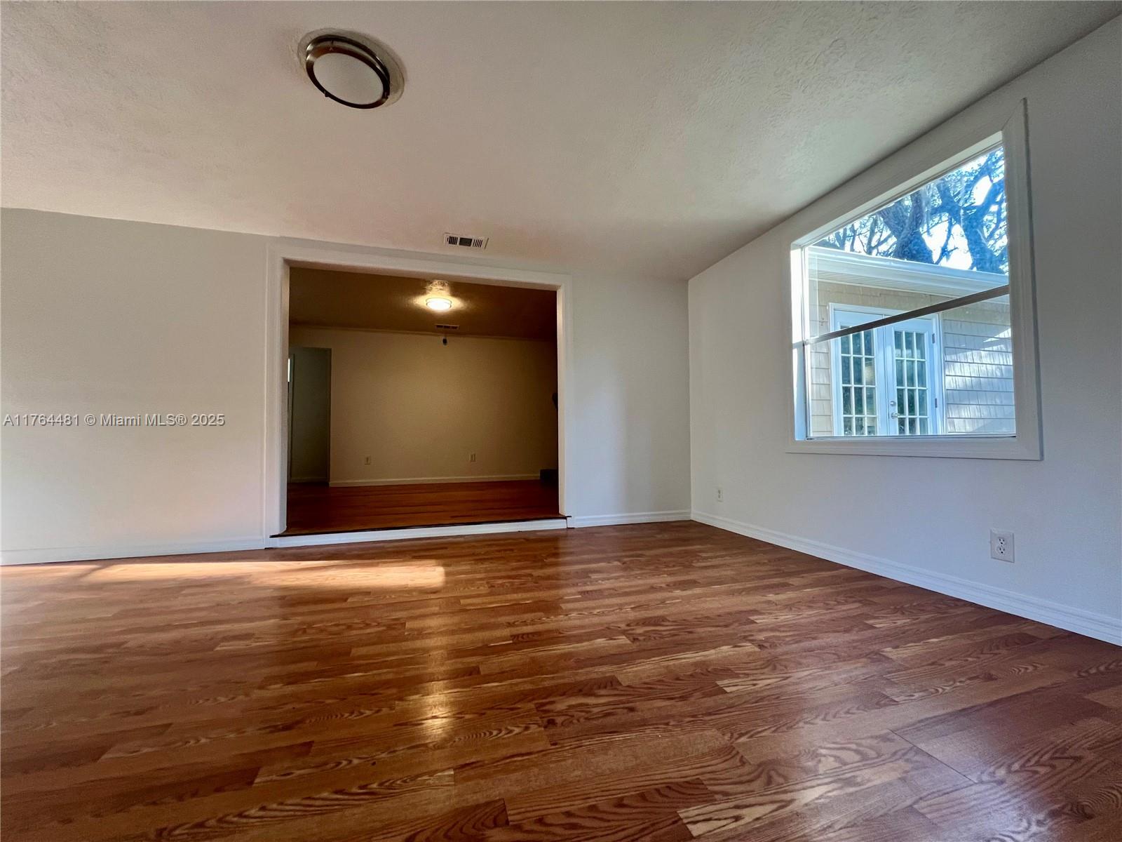 2985 Hilltop Road St. Augustine, FL 32086 - Photo 14 of 26 a view of an empty room with window and wooden floor