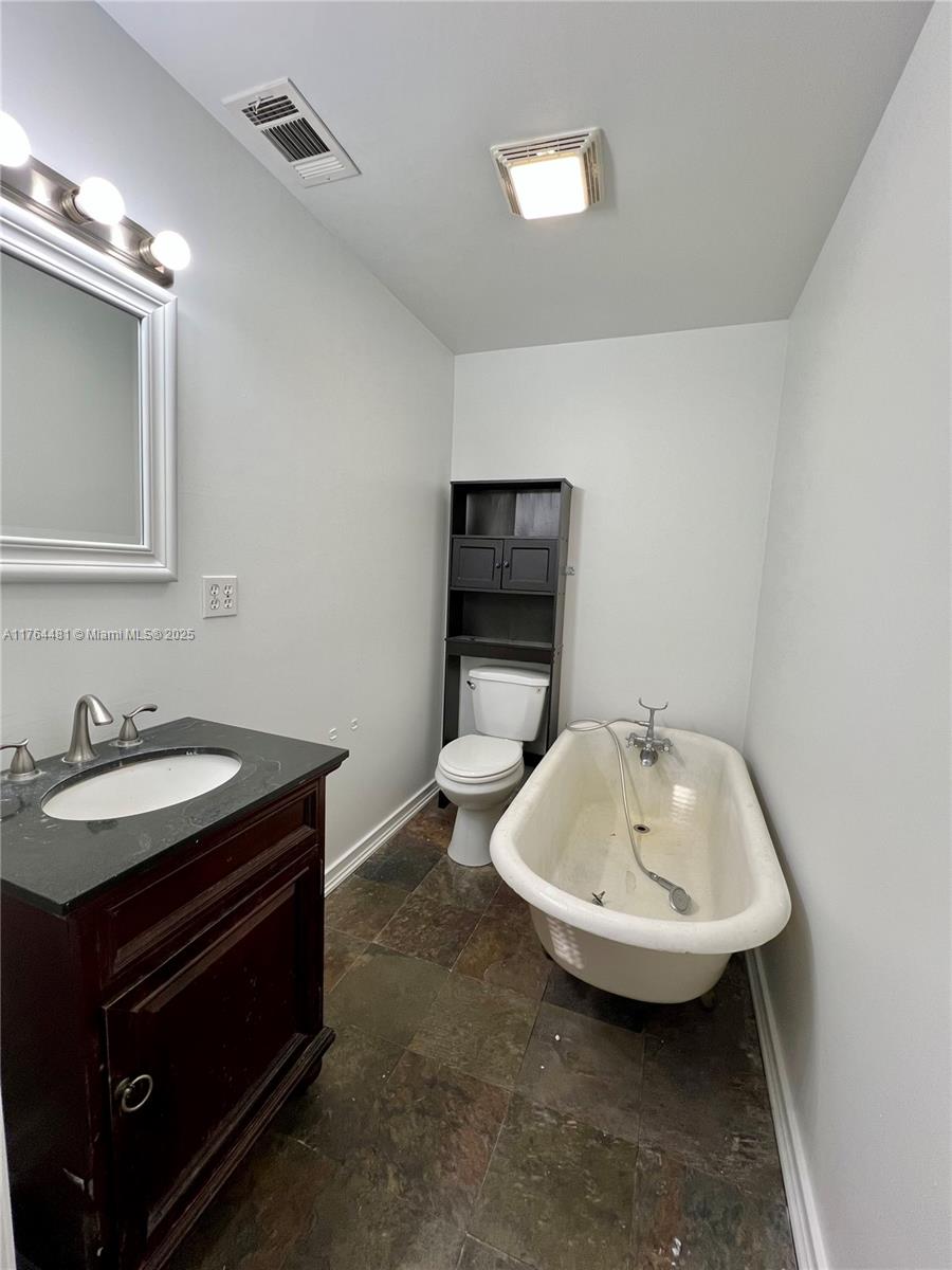 2985 Hilltop Road St. Augustine, FL 32086 - Photo 22 of 26 a bathroom with a sink and a mirror