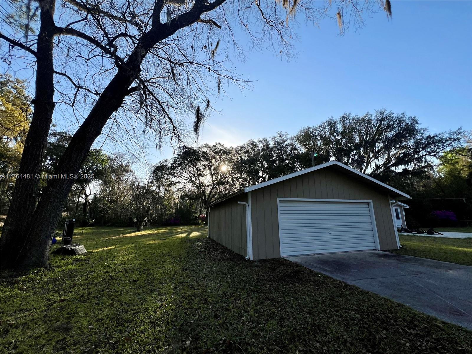 2985 Hilltop Road St. Augustine, FL 32086 - Photo 5 of 26 a house with green field in front of it