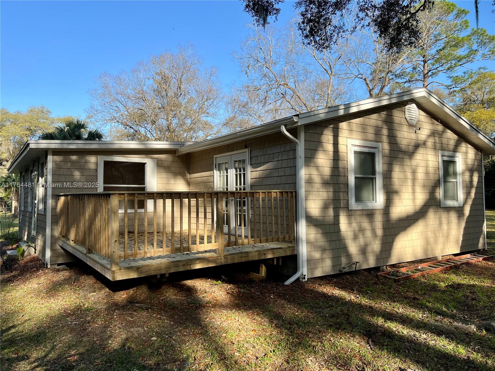 2985 Hilltop Road St. Augustine, FL 32086 - Photo 7 of 26 a view of backyard with deck and wooden floor