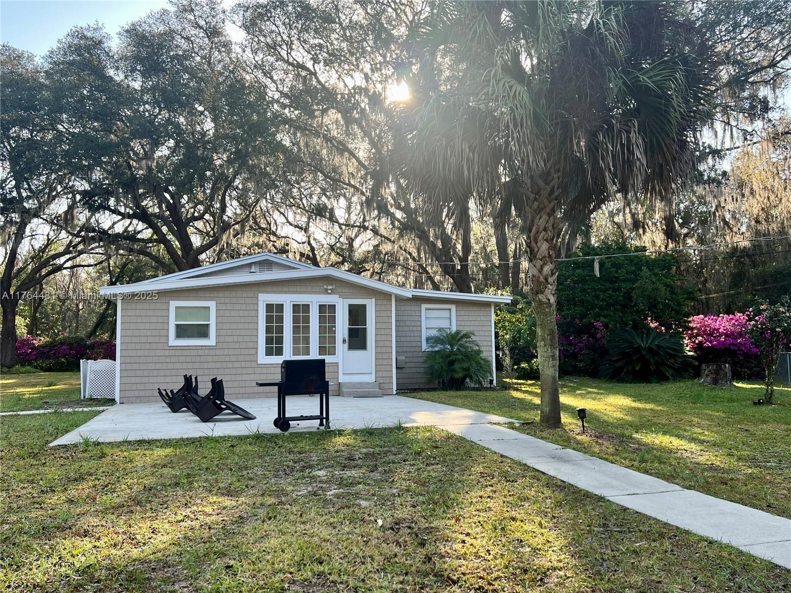 2985 Hilltop Road St. Augustine, FL 32086 - Photo 10 of 26 a view of a house with a yard and large tree