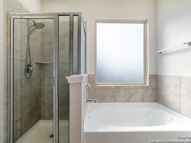 a bathroom with a shower and a bathtub