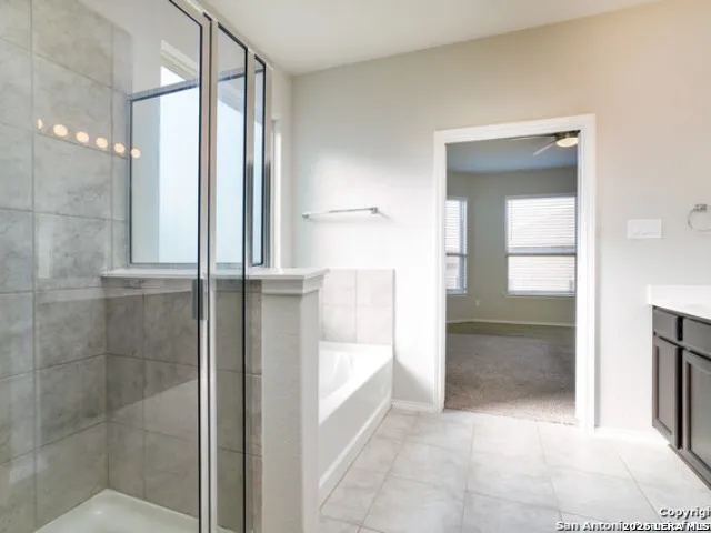 a bathroom with a bathtub and a shower