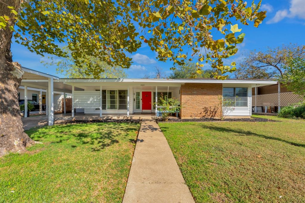 1224 Corona Drive Austin, TX 78723 - Photo 1 of 37 a front view of a house with a yard and porch