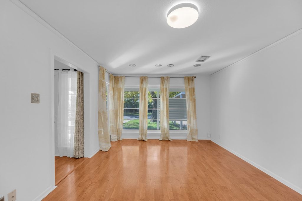 1224 Corona Drive Austin, TX 78723 - Photo 12 of 37 an empty room with wooden floor and windows