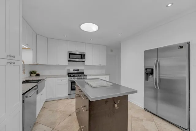a kitchen with a sink a stove and refrigerator