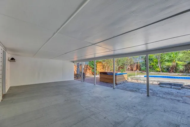 an empty room with large windows and view