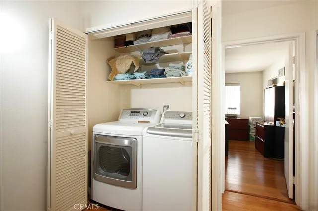 a view of a hallway with washer and dryer