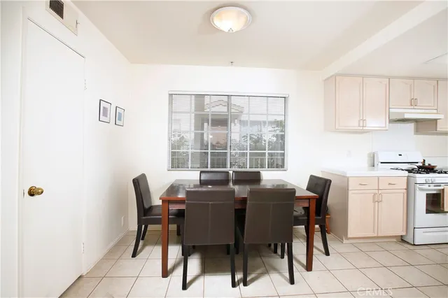 a view of a dining room with furniture and window