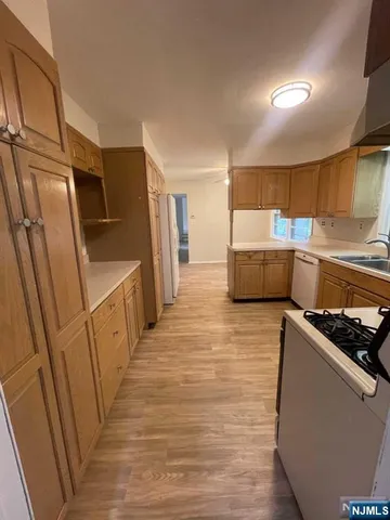 a kitchen with stainless steel appliances a refrigerator and a stove top oven