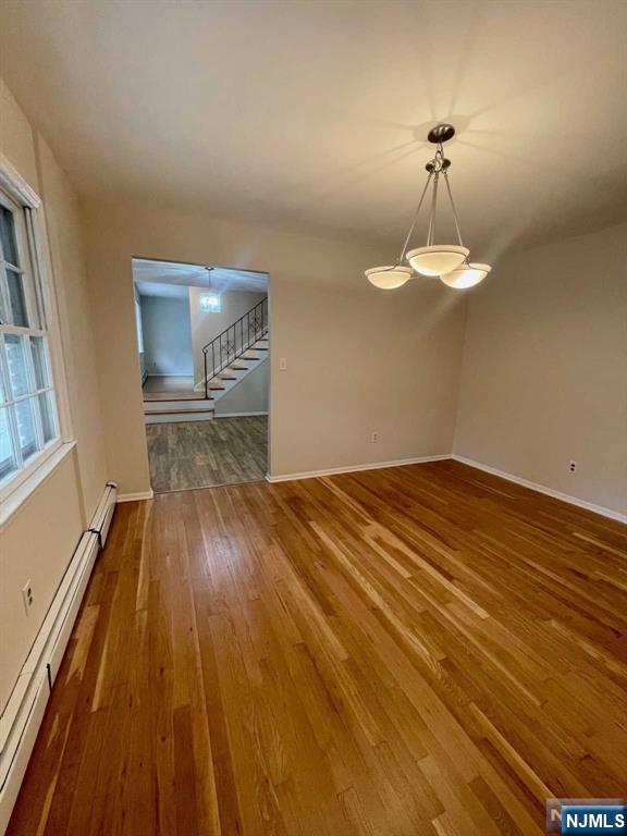 338 Queens Court Ridgewood, NJ 07450 - Photo 15 of 25 a view of empty room with a window and wooden floor
