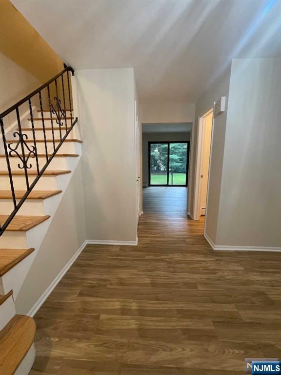 338 Queens Court Ridgewood, NJ 07450 - Photo 3 of 25 a view of an empty room with wooden floor and a window