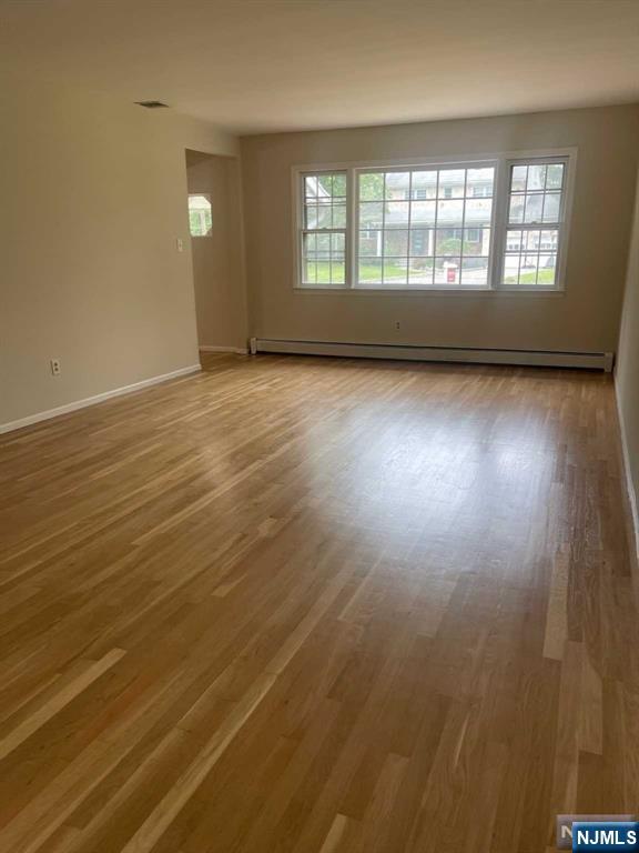 338 Queens Court Ridgewood, NJ 07450 - Photo 5 of 25 wooden floor in an empty room with a window