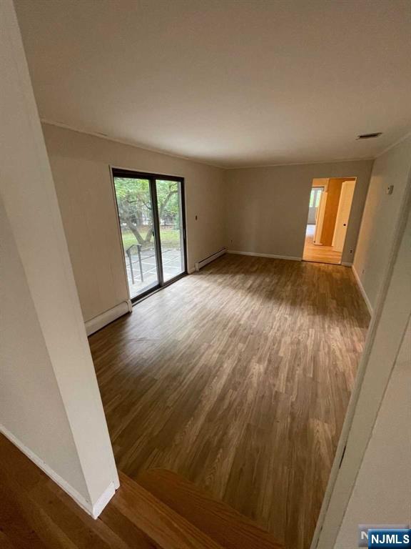 338 Queens Court Ridgewood, NJ 07450 - Photo 6 of 25 a view of empty room with wooden floor and fan