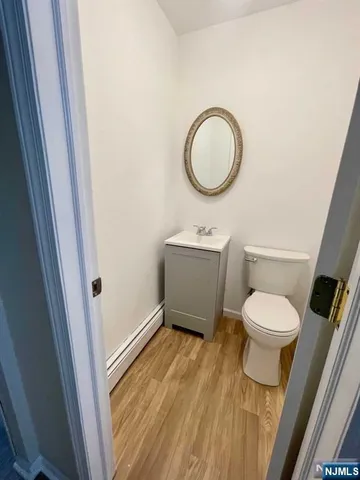 a bathroom with a toilet a sink and a mirror