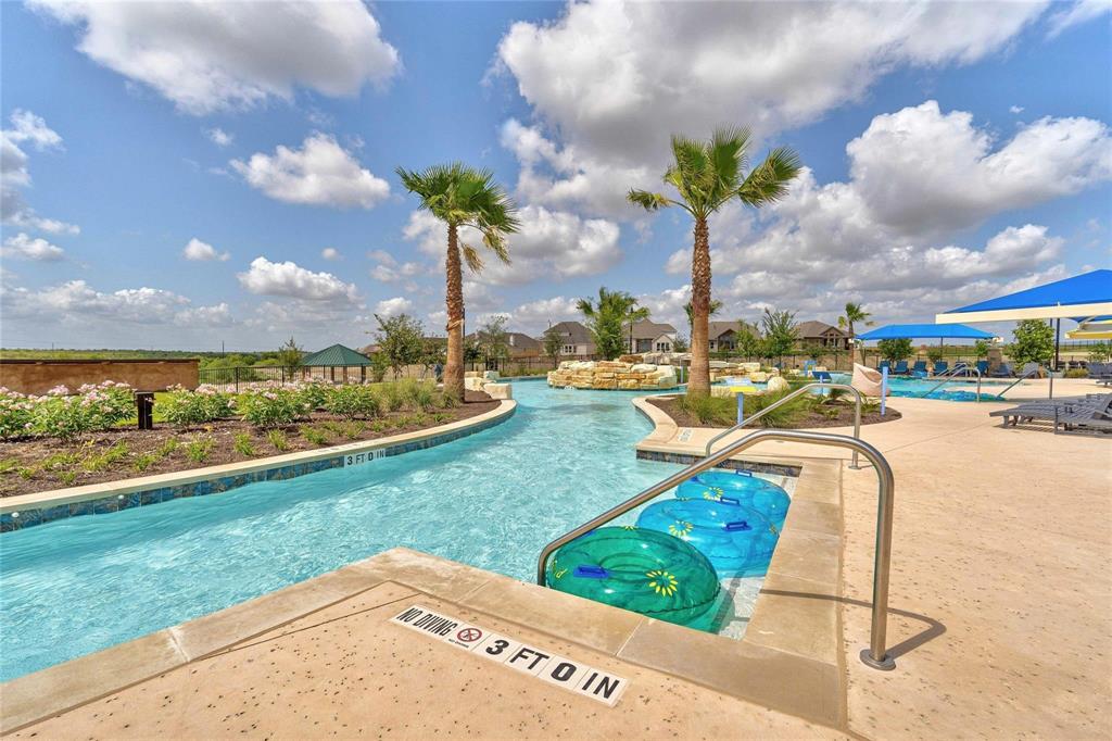208 Orange Road Buda, TX 78610 - Photo 26 of 31 A leisure pool with a lazy river and lush landscaping provides a refreshing oasis.