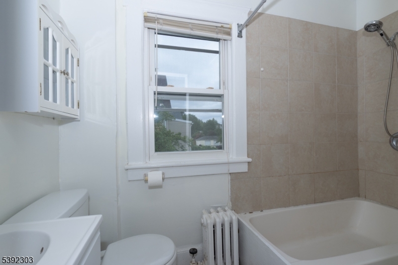 94 2nd Avenue Garwood, NJ 07027 - Photo 4 of 12 a bathroom with a toilet and a bathtub