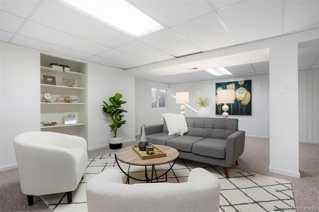 a living room with furniture and a potted plant