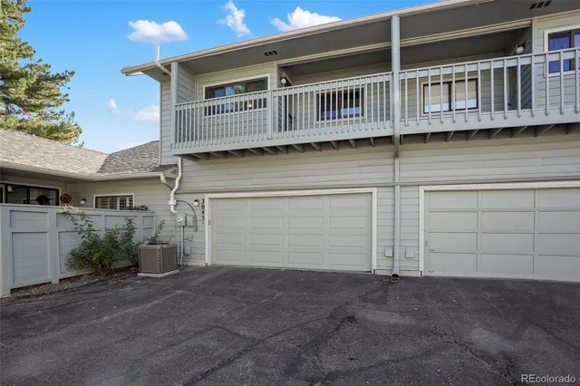 a view of a house with backyard and parking space