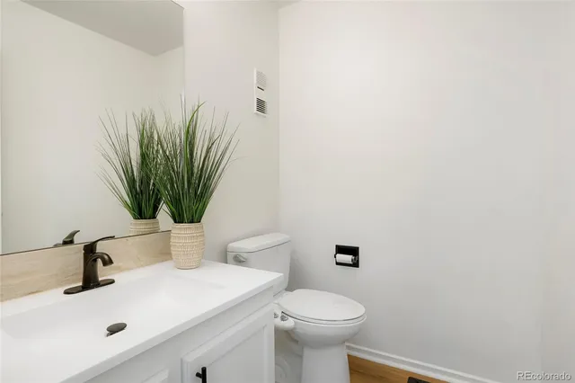a bathroom with a sink a toilet and mirror