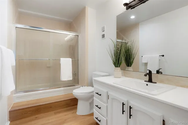 a bathroom with a sink toilet and shower