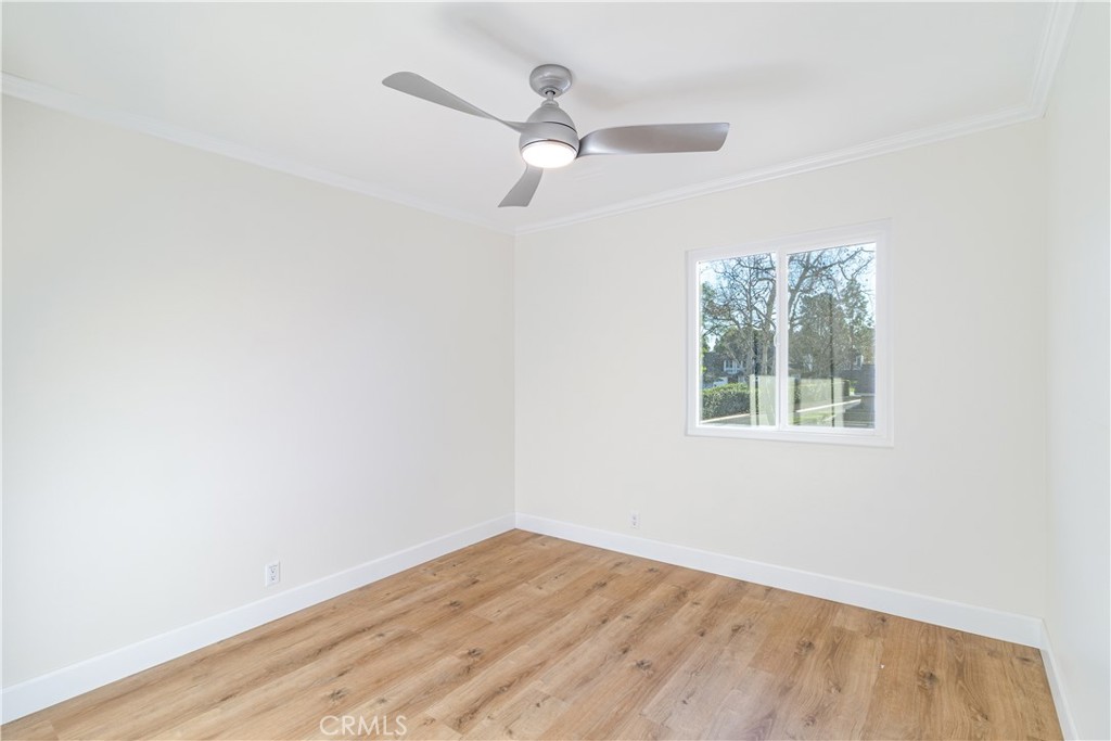 31 Windjammer Irvine, CA 92614 - Photo 12 of 31 an empty room with wooden floor ceiling fan and window