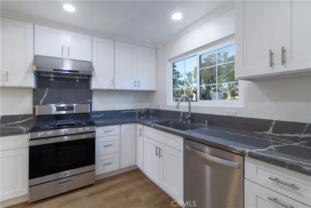 a kitchen with a sink stove and cabinets
