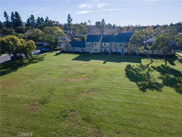 an aerial view of residential houses with outdoor space and swimming pool