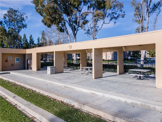 a view of a house with a big yard potted plants and large tree