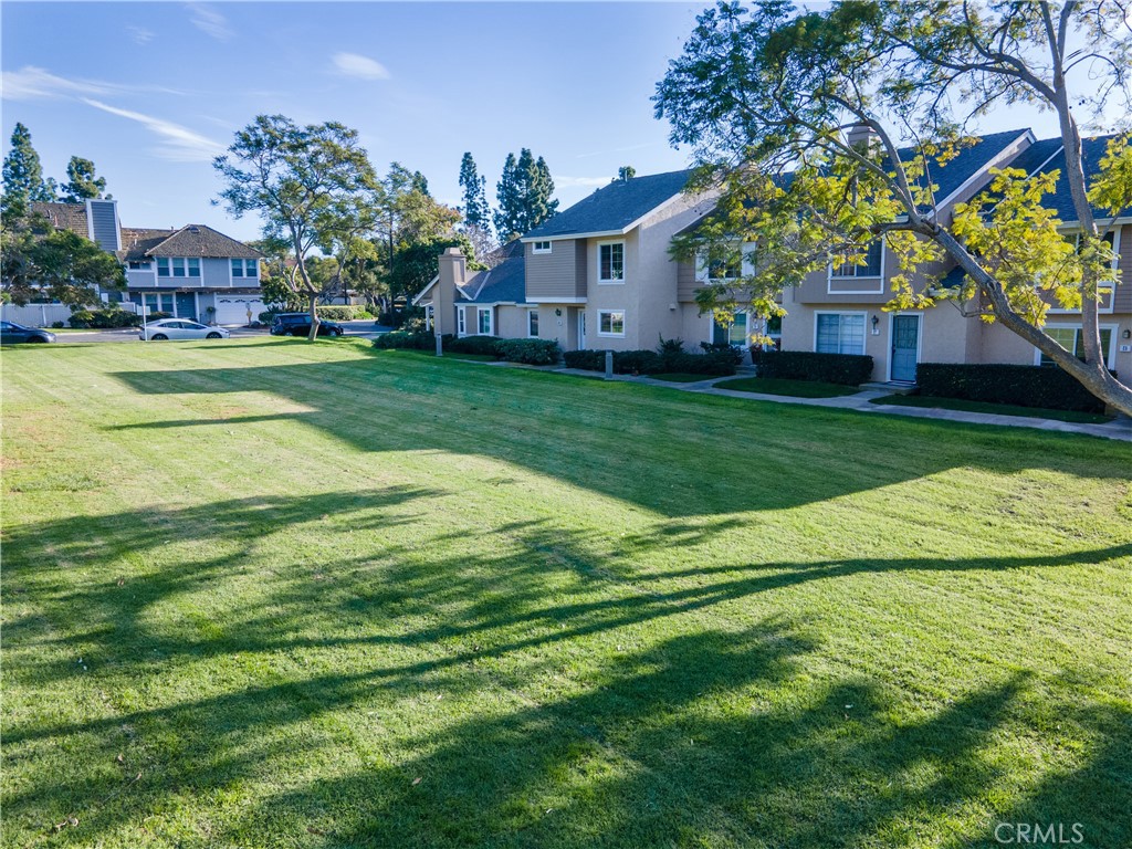 31 Windjammer Irvine, CA 92614 - Photo 28 of 31 a view of a house with a big yard potted plants and large tree