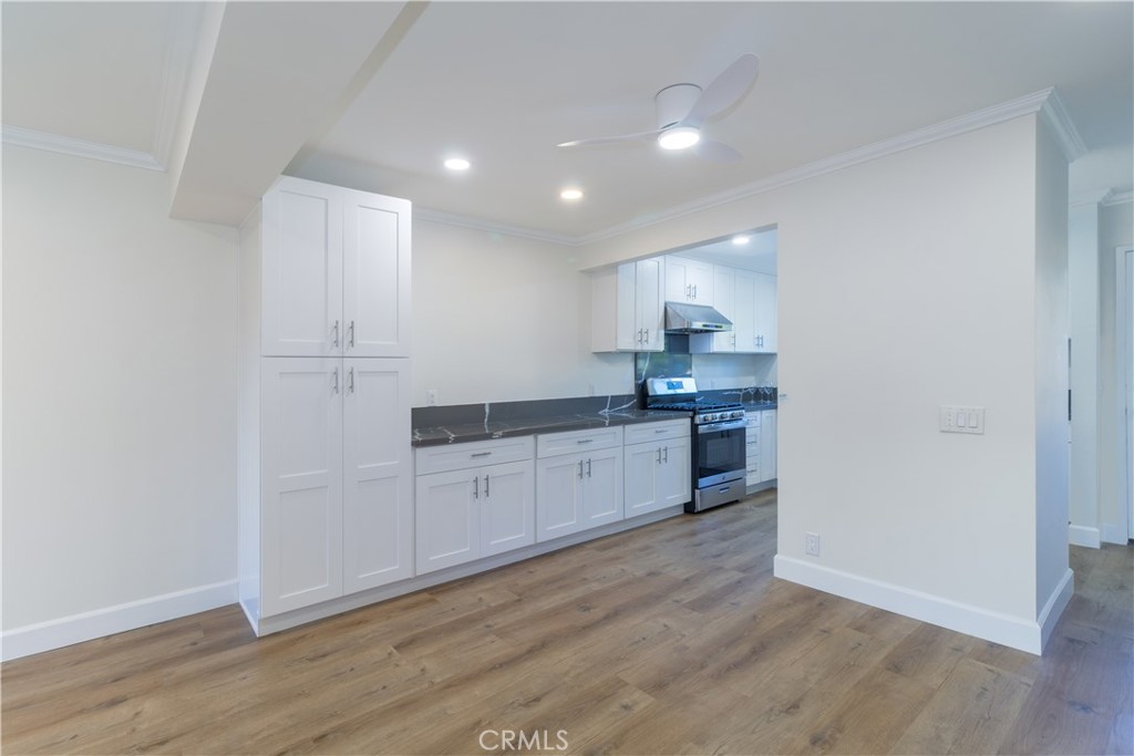 31 Windjammer Irvine, CA 92614 - Photo 4 of 31 a kitchen with granite countertop white cabinets and white appliances