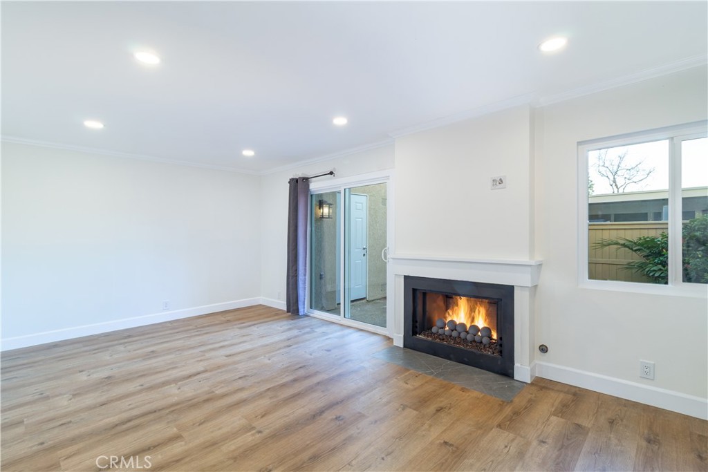 31 Windjammer Irvine, CA 92614 - Photo 6 of 31 a view of an empty room with wooden floor fire place and windows