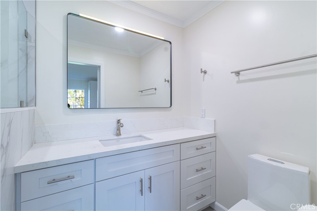 31 Windjammer Irvine, CA 92614 - Photo 9 of 31 a bathroom with a toilet sink and mirror