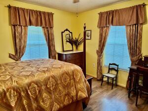 1515 Southwest 19th Terrace Okeechobee, FL 34974 - Photo 20 of 39 a bedroom with a bed and wooden floor