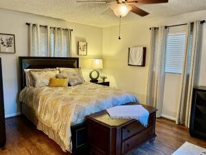 1515 Southwest 19th Terrace Okeechobee, FL 34974 - Photo 7 of 39 a bedroom with bed and wooden floor