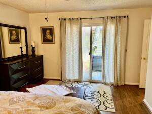 1515 Southwest 19th Terrace Okeechobee, FL 34974 - Photo 8 of 39 a bedroom with a bed and wooden floor