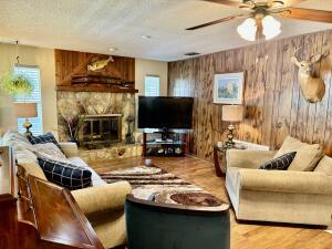 1515 Southwest 19th Terrace Okeechobee, FL 34974 - Photo 10 of 39 a living room with furniture and a flat screen tv