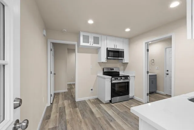 a kitchen with a refrigerator stove and microwave