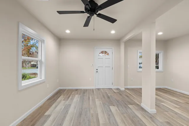 wooden floor in an empty room with a window