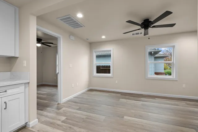 wooden floor in an empty room with a window