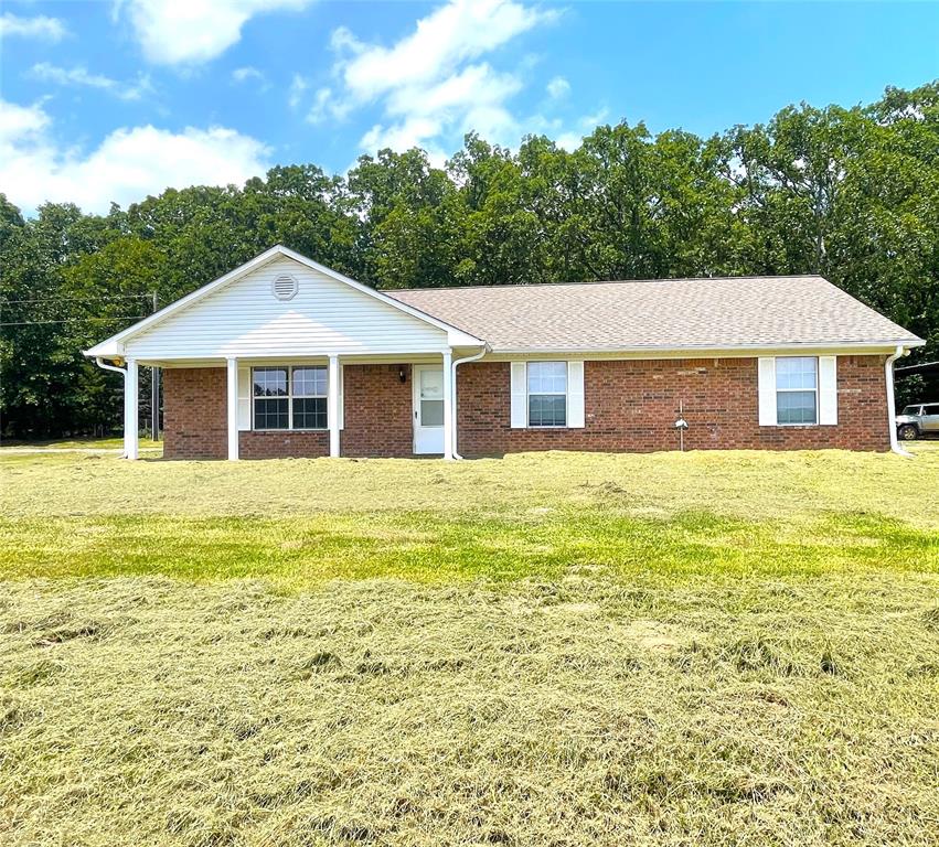 180 Cr 3320 Road Avery, TX 75554 - Photo 1 of 18 a front view of a house with a garden