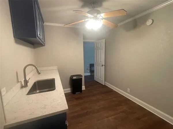a kitchen with a sink and a refrigerator