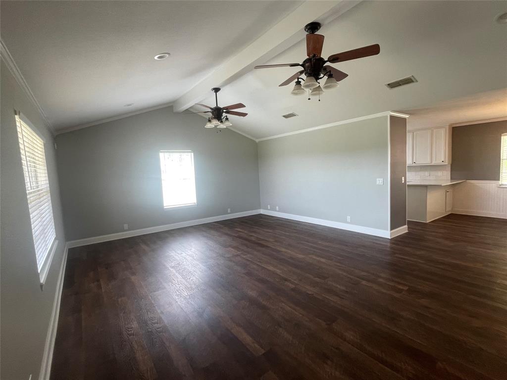 180 Cr 3320 Road Avery, TX 75554 - Photo 6 of 18 a view of empty room with wooden floor and fan
