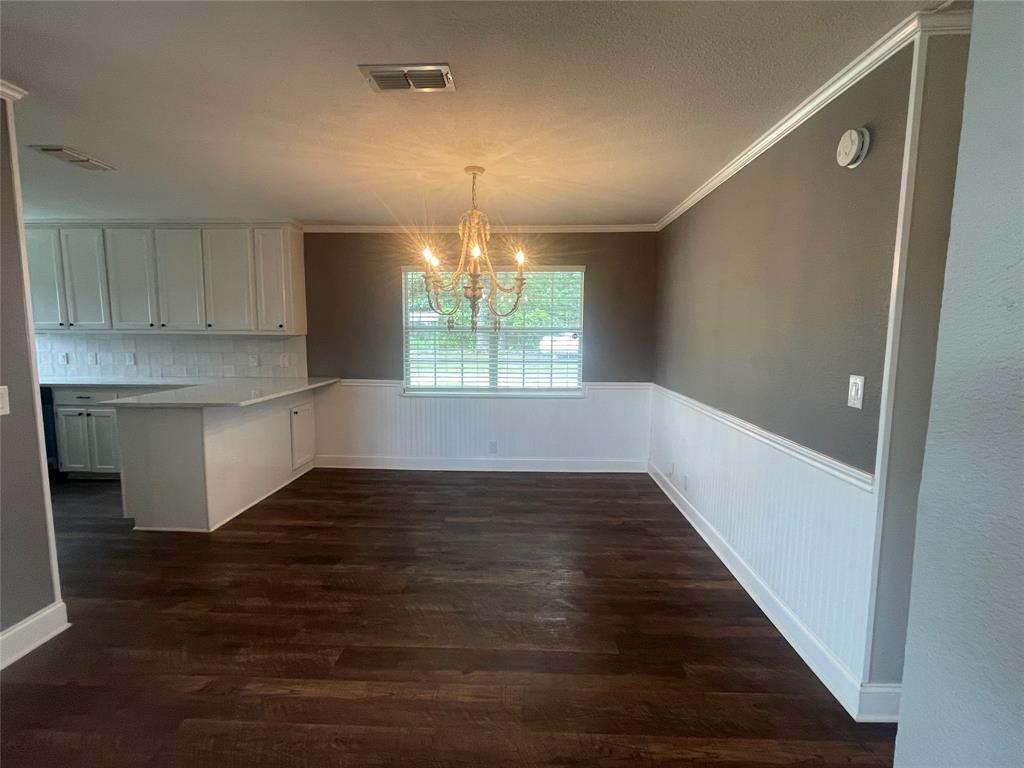 180 Cr 3320 Road Avery, TX 75554 - Photo 9 of 18 an empty room with wooden floor and windows