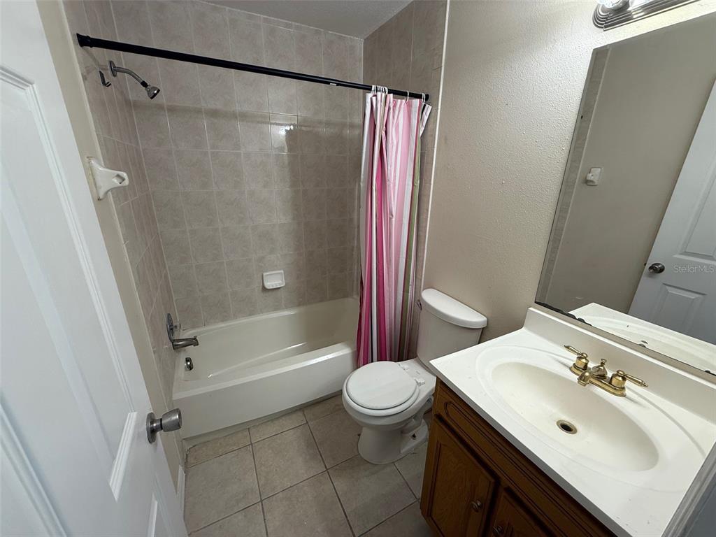 7319 Holiday Drive Spring Hill, FL 34606 - Photo 12 of 20 a bathroom with a sink toilet and shower