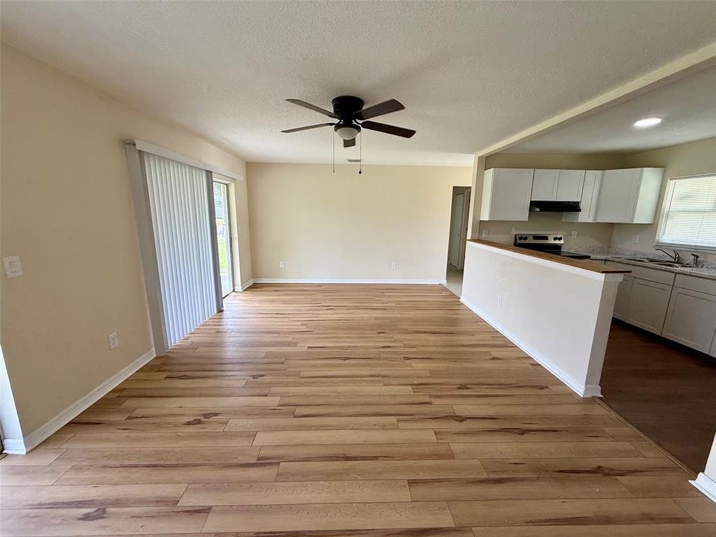 7319 Holiday Drive Spring Hill, FL 34606 - Photo 4 of 20 a view of a kitchen with a sink and a refrigerator