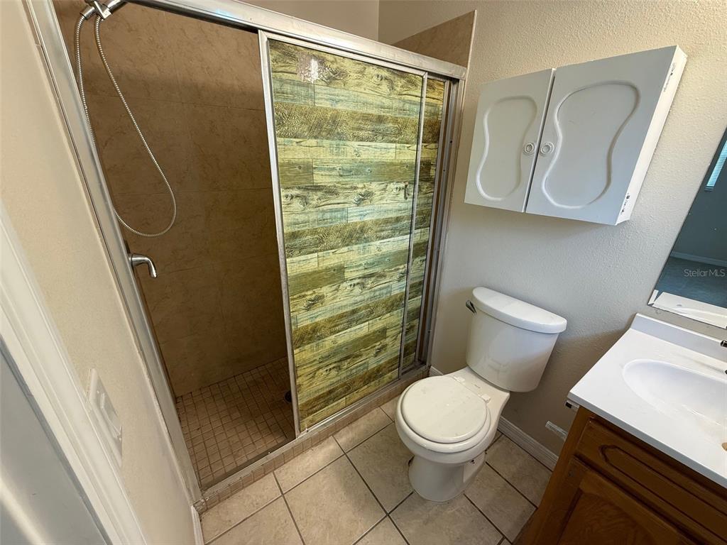 7319 Holiday Drive Spring Hill, FL 34606 - Photo 9 of 20 a bathroom with a toilet and a shower