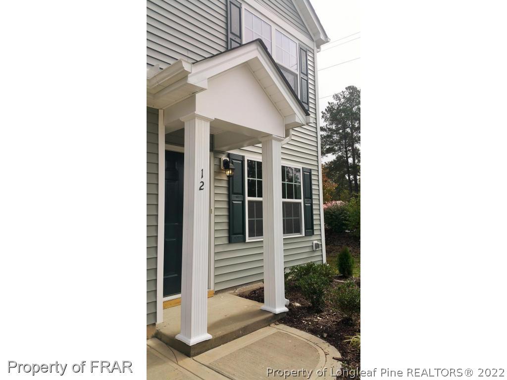 12 River Oak Street Spring Lake, NC 28390 - Photo 2 of 34 a view of a house with a small yard and floor to ceiling window